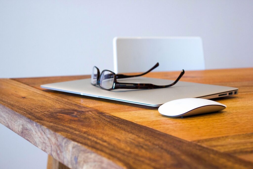 Laptop, glasses and a mouse.